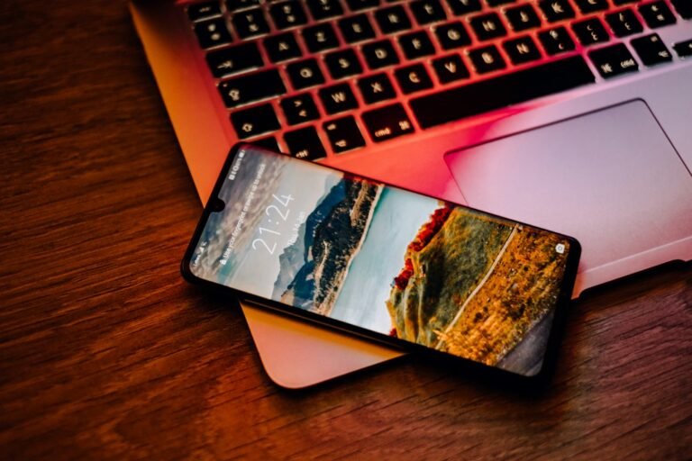 Feedbuzzard com latest articles read on a smartphone next to a laptop