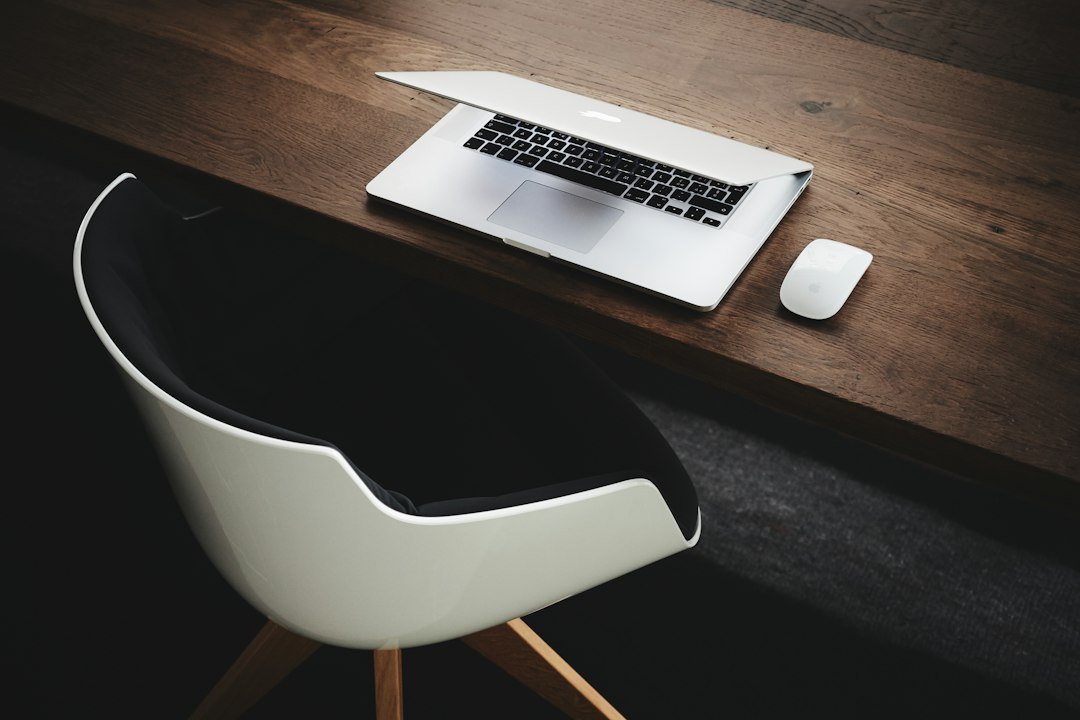MacBook beside a computer mouse on a table, a simple workspace for automating repetitive tasks