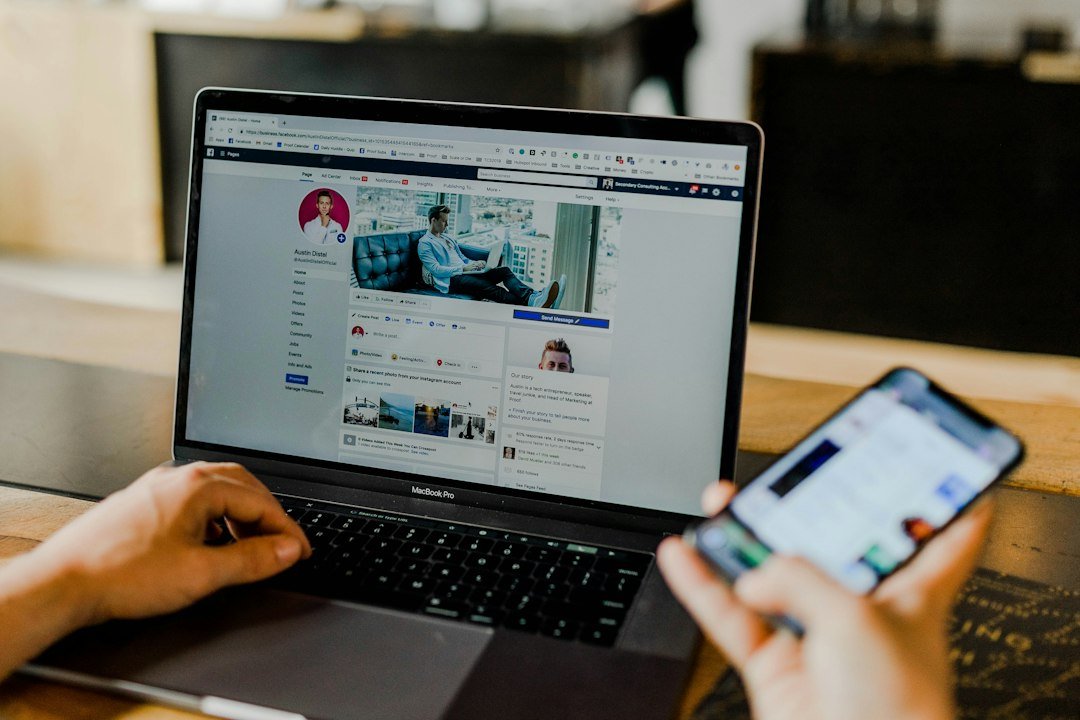 Person checking social media stats on a laptop and smartphone