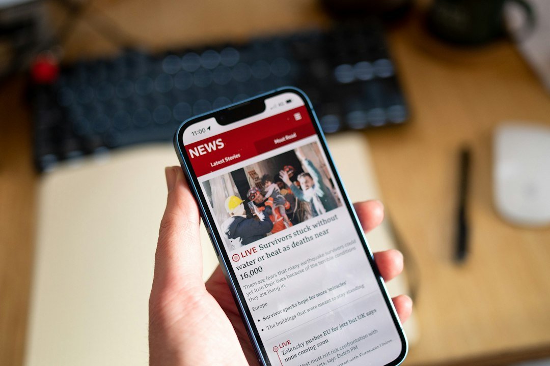 Person holding a smartphone to browse the latest online articles