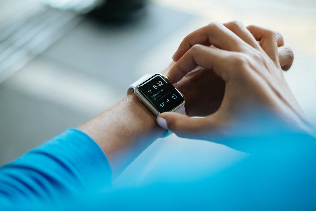 Person using a smartwatch while keeping up with technology topics