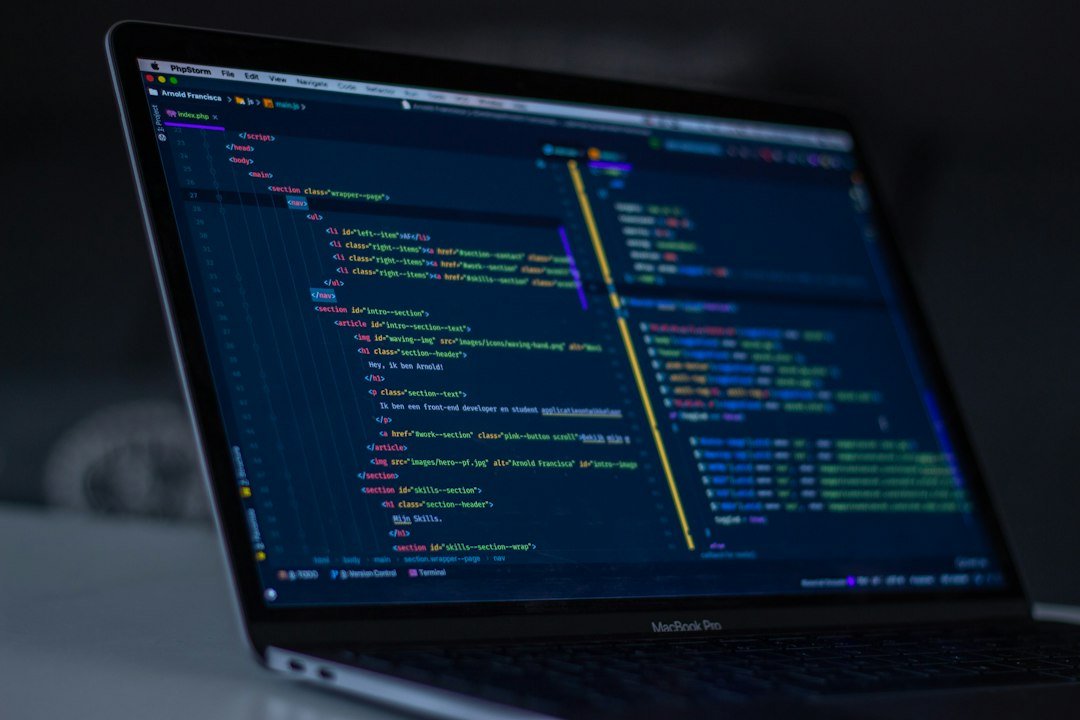 Software programgeeks guide shown with a MacBook displaying programming code